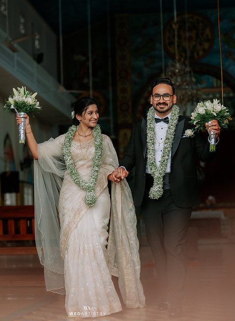 Bride and groom with flower bokeh on their hands
