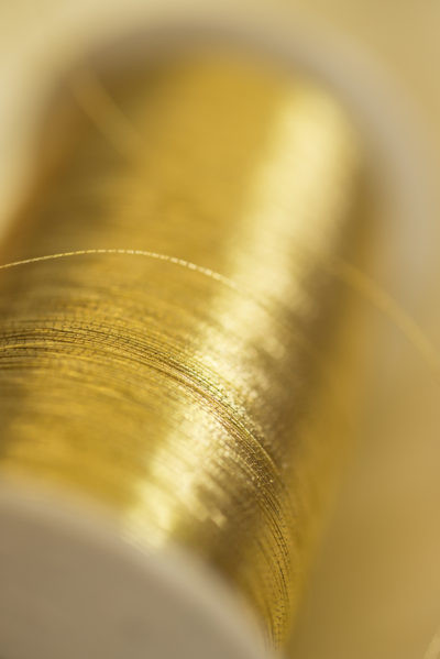 Golden thread on a bobbin