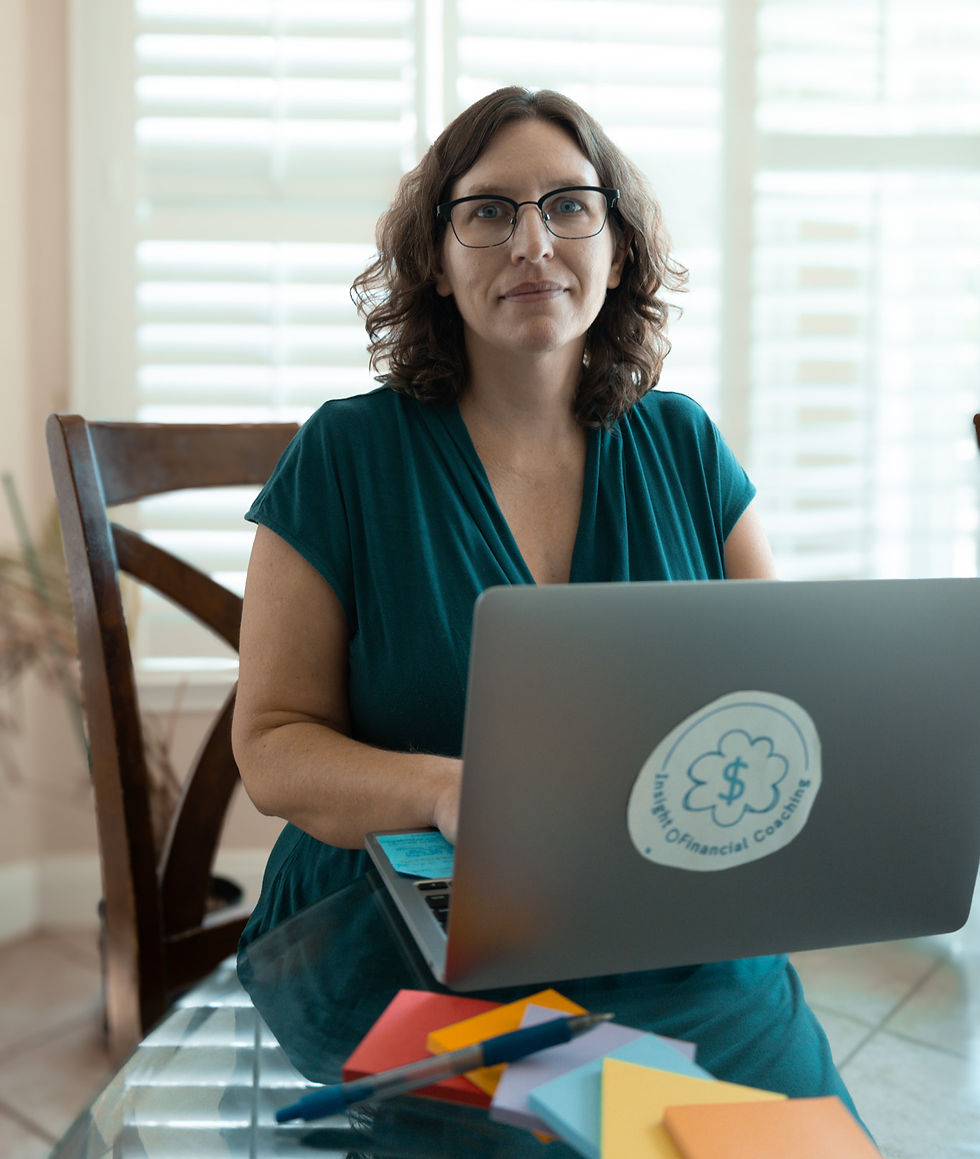 Financial Coach Sabrina in front of her laptop at the kitchen table