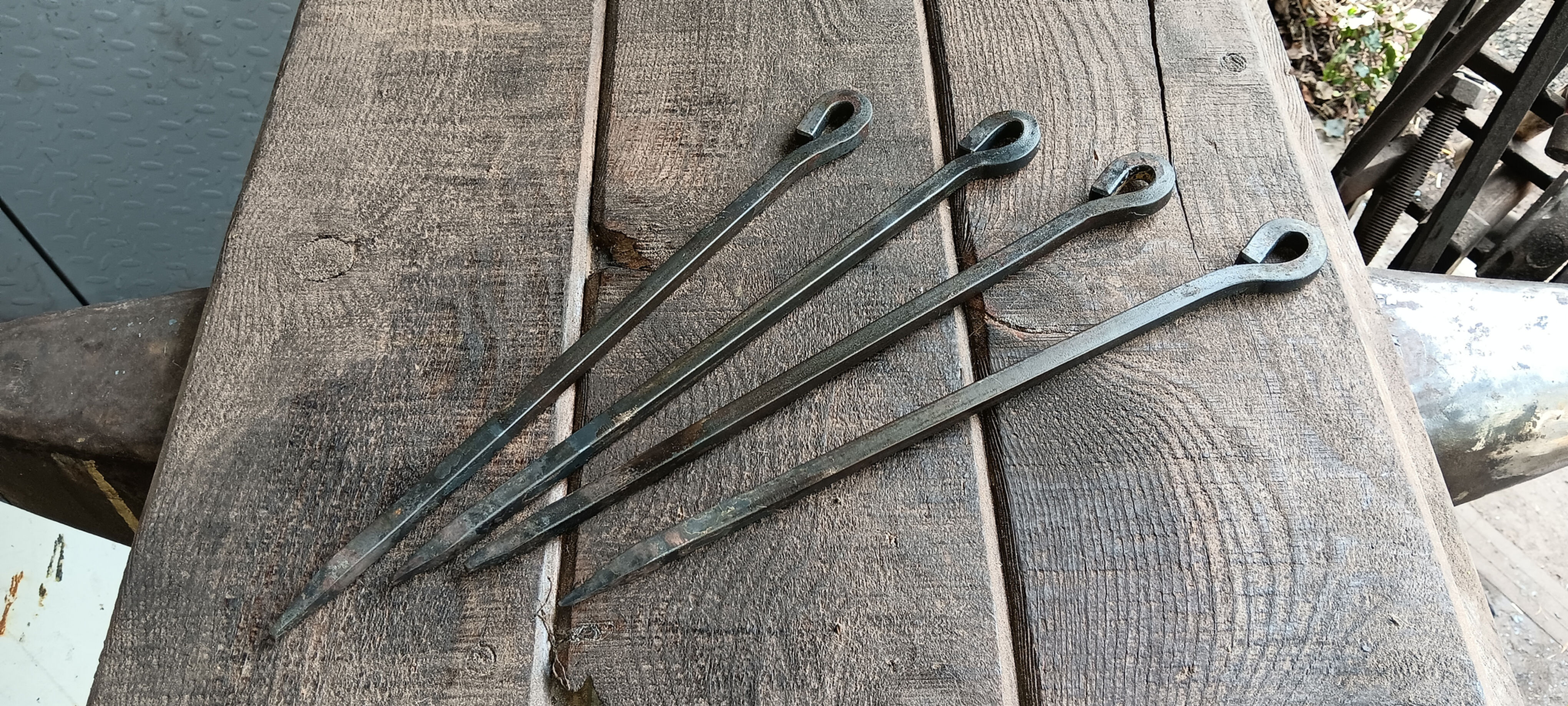 (4) 10.5" hand forged tent stakes