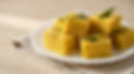 plate-of-soft-yellow-dhokla-garnished-with-green-chilies-and-curry-leaves.jpeg