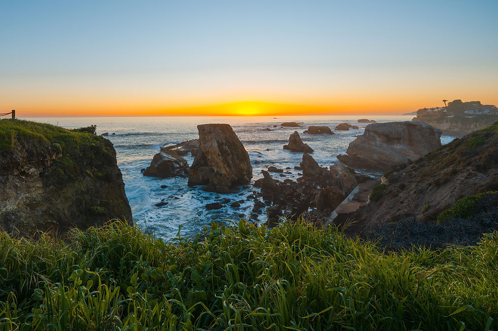 Sea stacks and rocky coves along the coast at sunset