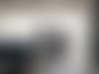 Two founders disconnected at conference table, tension in body language, warm daylight