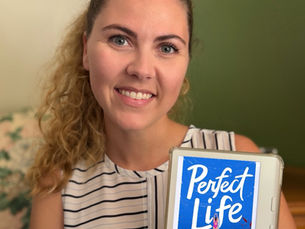 Books with Brittani holds her kobo eReader that shows the cover of Meredith Lavender and Kendall Shores' book "Perfect Life"