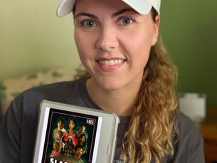 Books with Brittani holds her Kobo eReader that shows the book cover of E. L. Chen's "Slasher Summer"