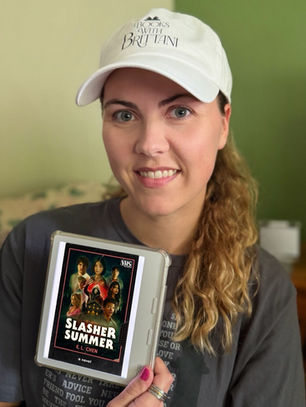 Books with Brittani holds her Kobo eReader that shows the book cover of E. L. Chen's "Slasher Summer"
