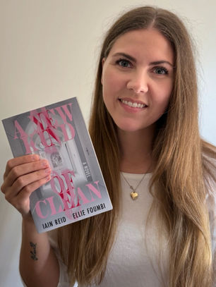 Books with Brittani holds a copy of Iain Reid's and Ellie Foumbi's book "A New Kind of Clean"