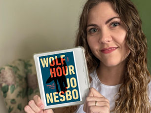Books with Brittani holds her Kobo eReader that shows the cover of Jo Nesbø's book, "Wolf Hour"