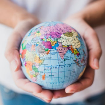 close-up-of-hand-holding-globe_23-214781