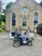 Carrie-Ann sitting in a Tramper outside Bowless visitor centre