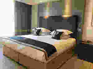 King size hotel room bed. Cushions on the Bed have the letters R and P on them