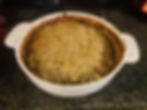 Pie dish filled with chicken and vegetable crumble