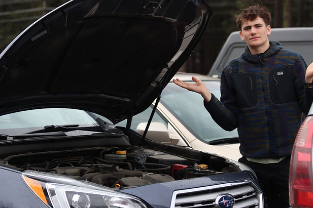 Benjamin Jerome (12) wonders how to change the oil in his car. Photo Credit: Avery Houghton