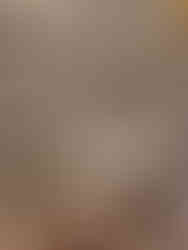 A traditional powder room featuring floral patterned wallpaper with pedestal sink and gold oval mirror