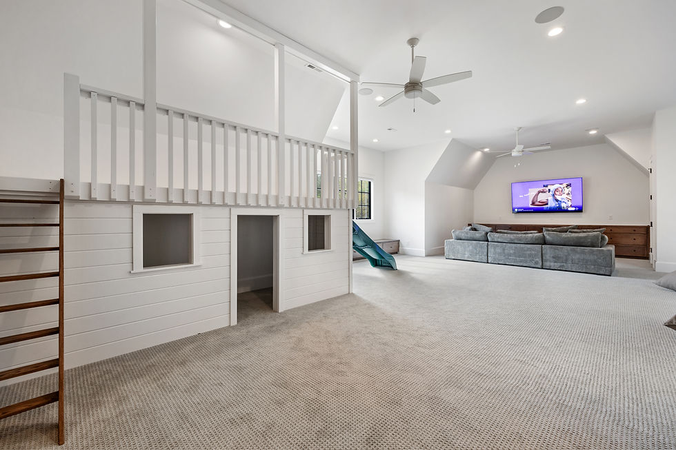 Playroom built by David Rogers Builders in Charlotte, NC with a rock wall, teen area and playhouse with lighting