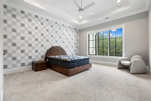 wallpaper design behind headboard in a kids bedroom serving as the focal point behind a brown wood headboard