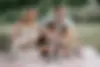 Family-of-5-sitting-in-a-park-by-Pauline-Mattia.webp