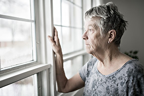 Older-woman-looking-out-window-scaled.jpeg