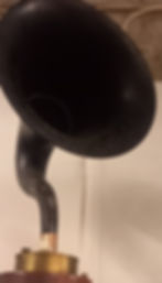 An early 19th Century Grampone with a black speak on a brass and wood base.