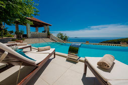 Luxury villa pool with ocean view, sunny day, Villa Soline.