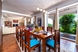 Dining area with wooden table and chairs, Villa Soline, offering a great view.