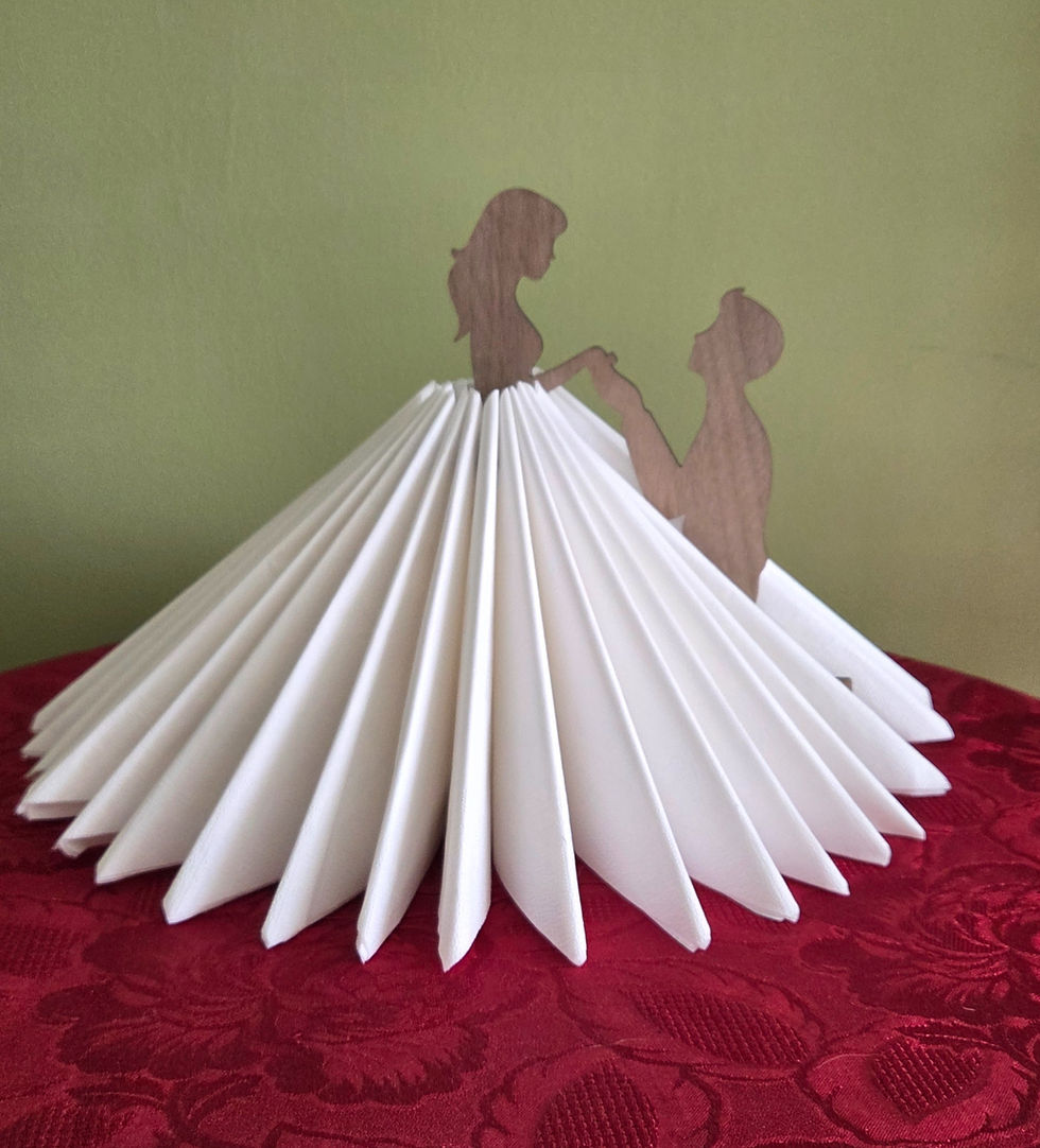 Bride and Groom Napkin Holder, made from walnut, holding paper napkins the shape the brides dress.