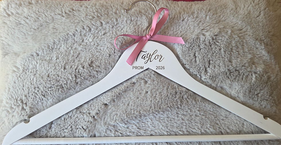 Thumbnail: White coat hanger with a pink ribbon and engraving saying Taylor - Prom - 2026