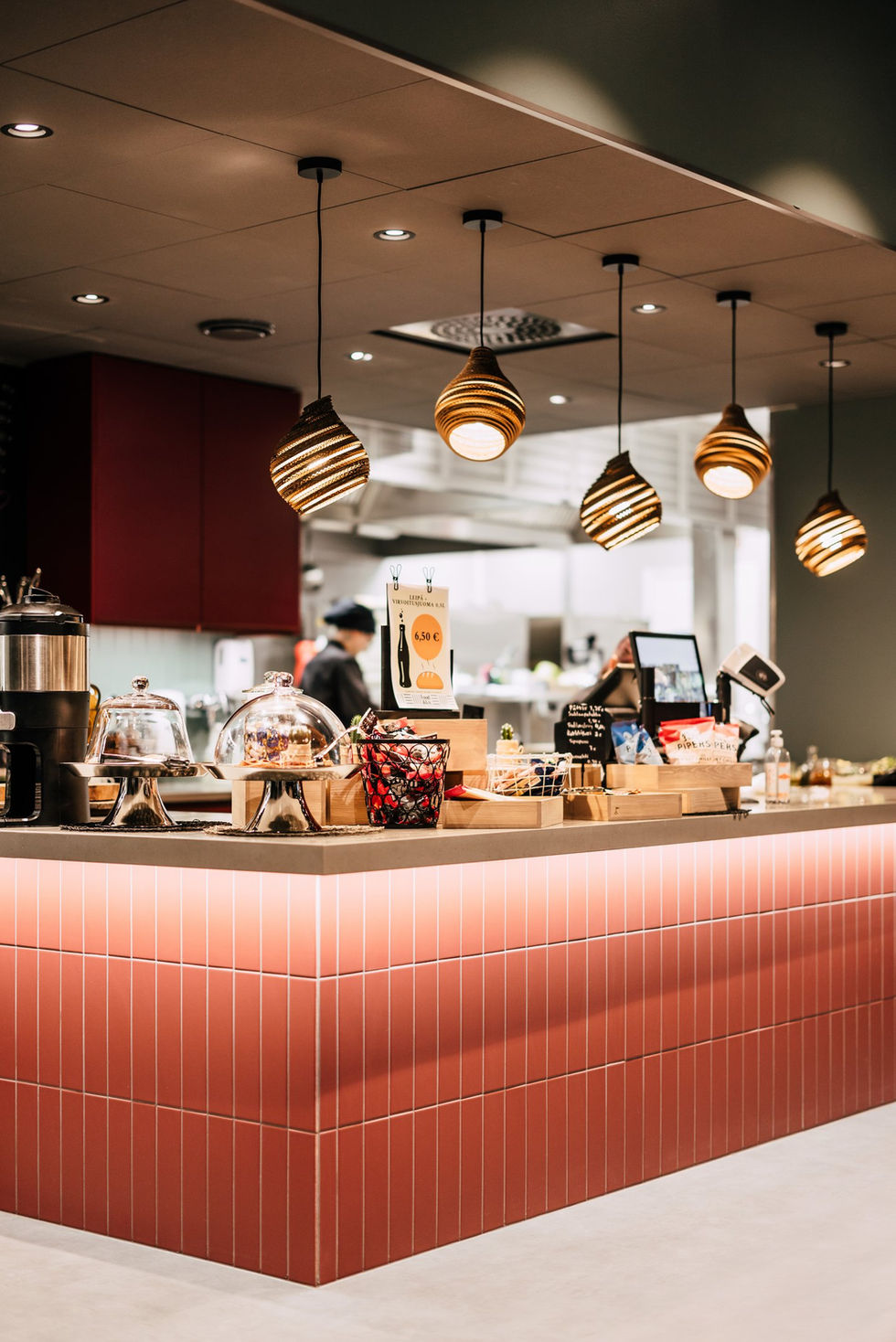 Modern cafe interior with warm lighting and counter.