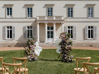 Décor de cérémonie de mariage avec fleurs géantes en papier, compositions florales et scénographie florale sur mesure à Nantes.