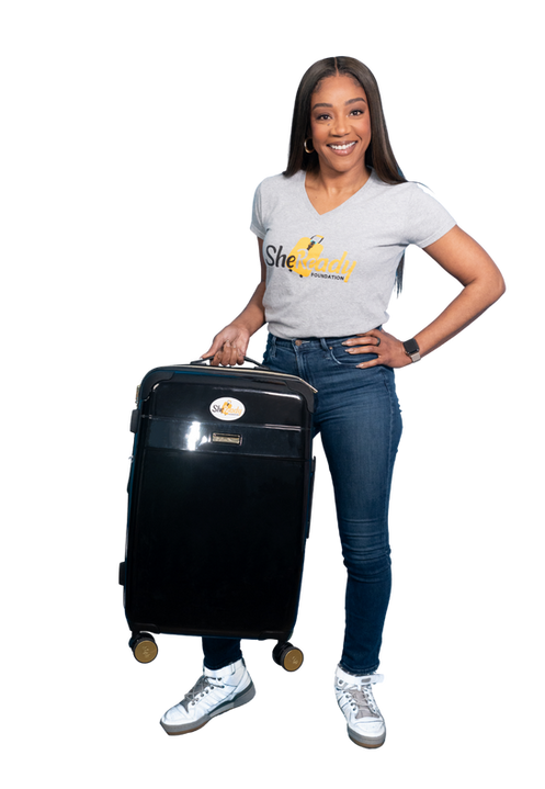 Tiffany haddish holding a luggage.png