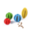 Set of colorful natural rubber dog toys, including round balls and a yellow football shape, filled with treats to promote int