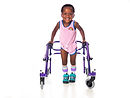 Young girl with cerebral palsy taking steps with her walker.jpg