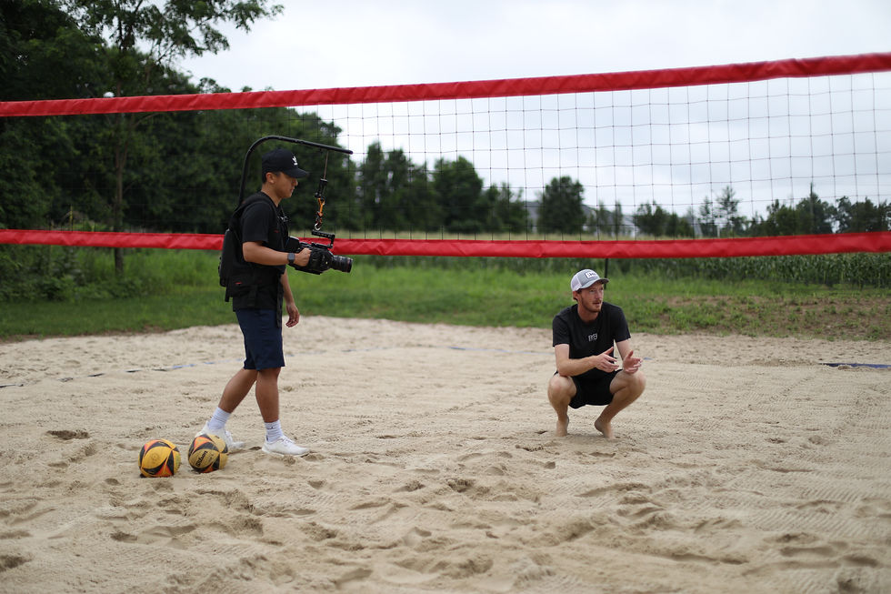 In this image the producer is crouching down in the sand giving direction to the director of photography Howard standing by.