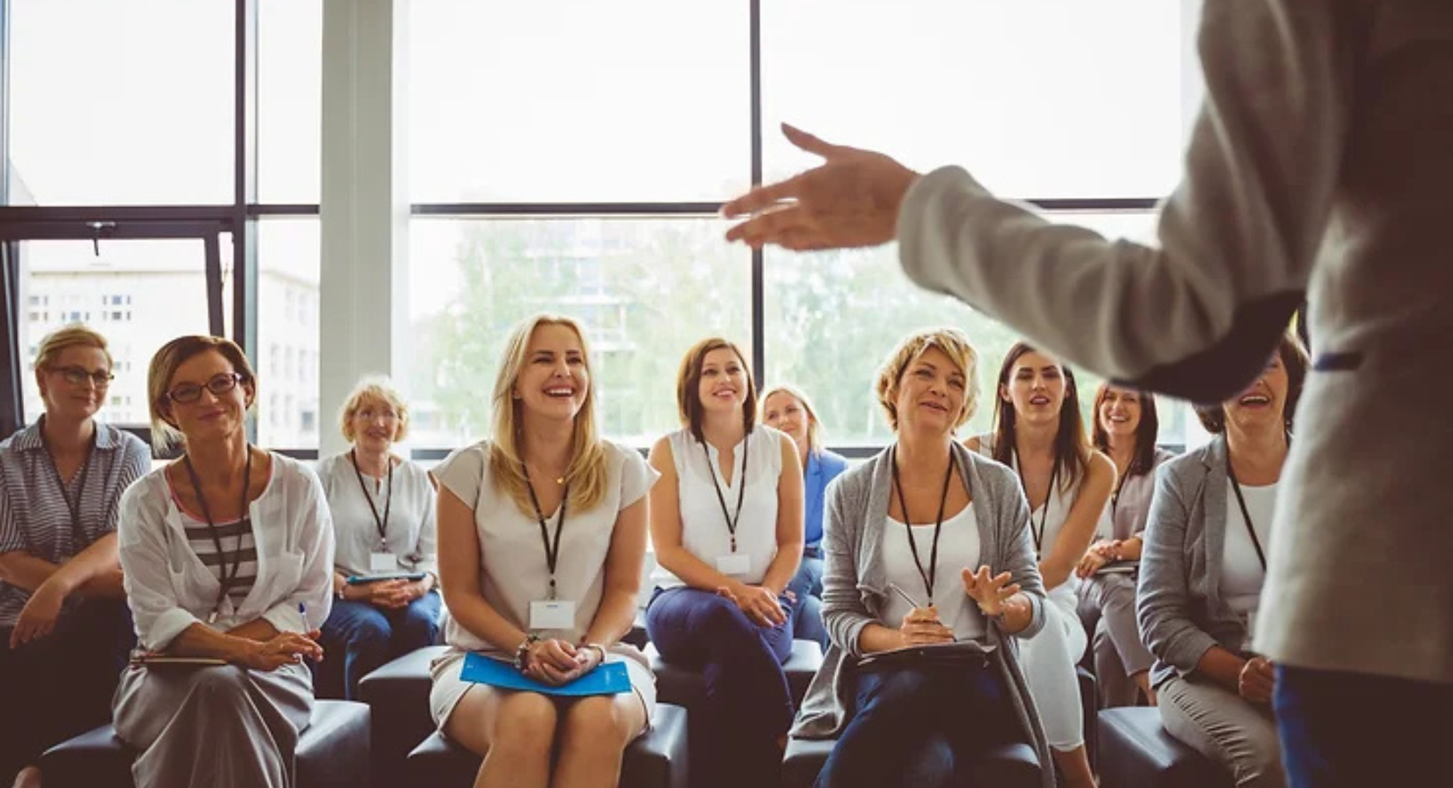 Women attentively listening to speaker at conference