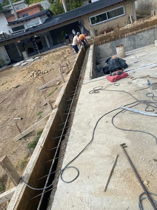 Construction site with workers and tools on concrete.