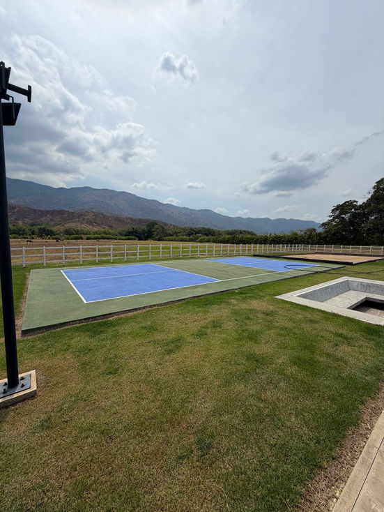 Outdoor sports court with mountains in the background.