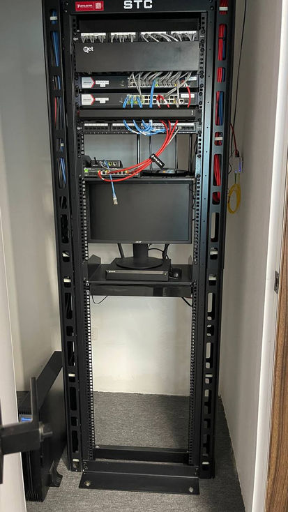 Server rack with equipment and cables.