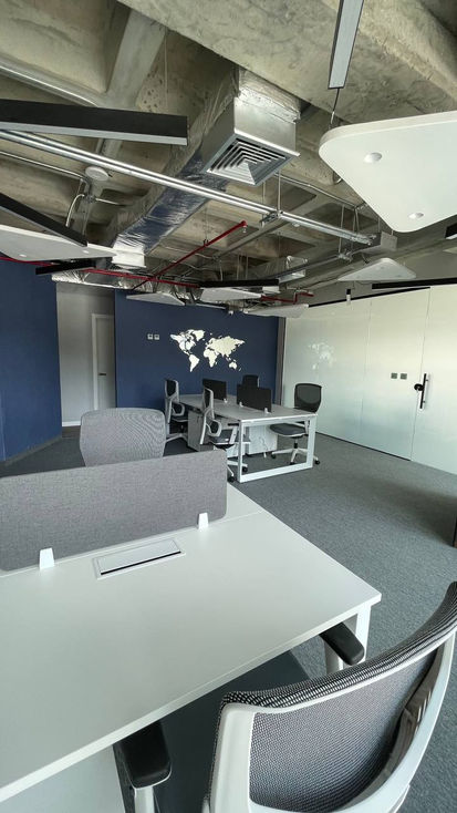 Modern office space with world map on wall.
