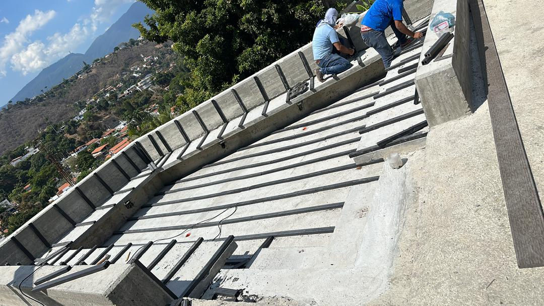 Two people working on a concrete construction site.