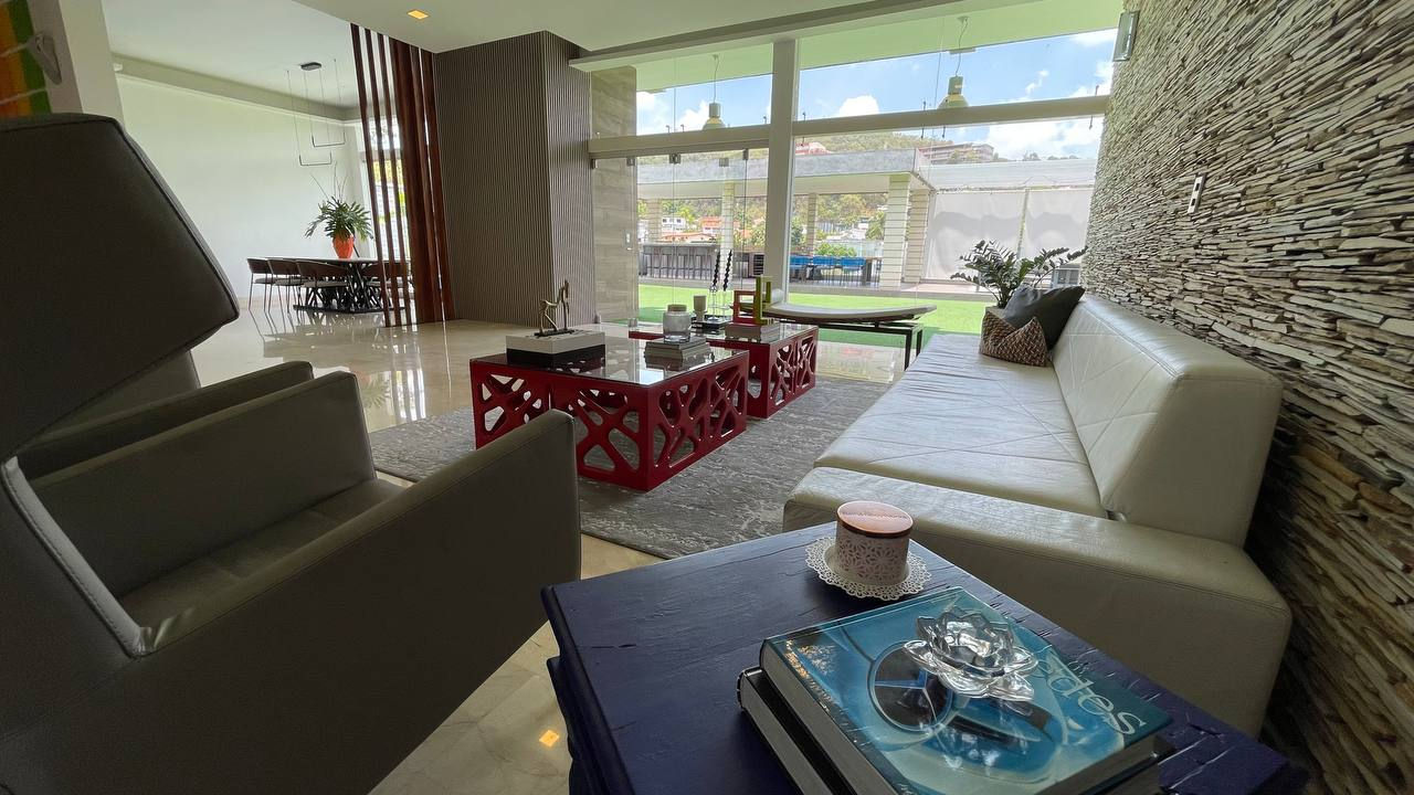Modern living room with large windows and stylish furniture.