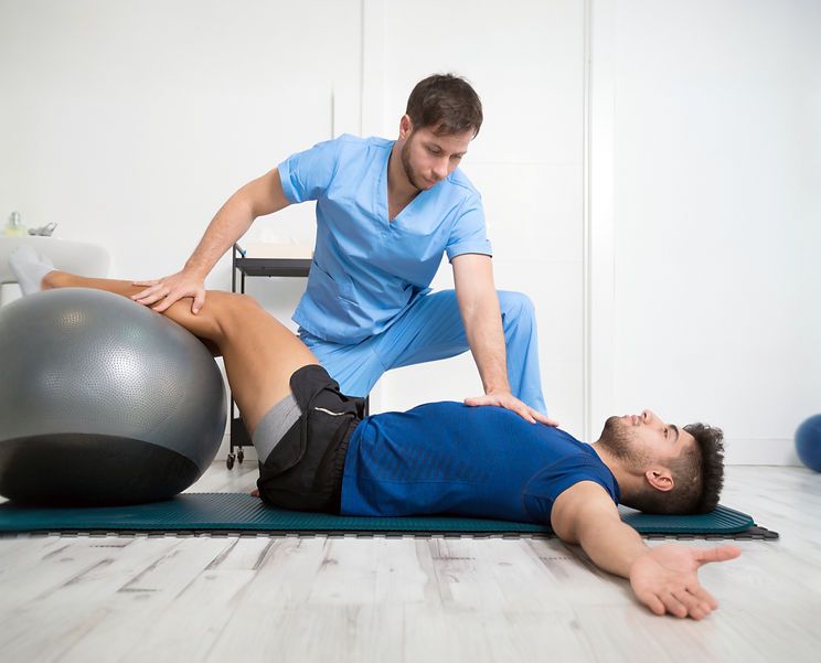 physiotherapist-helps-handsome-young-patient-with-pilates-exercises_edited_edited_edited_e