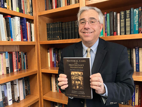 Montana Bible College Vice President of Academics Dr. Andre Gazal displays a copy of a book in which he was recently published.