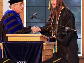 Montana Bible College 2026 graduate Noel Chittenden shakes hands with MBC Vice President of Academic Affairs Dr. Andre Gazal during the 2026 graduation ceremony.