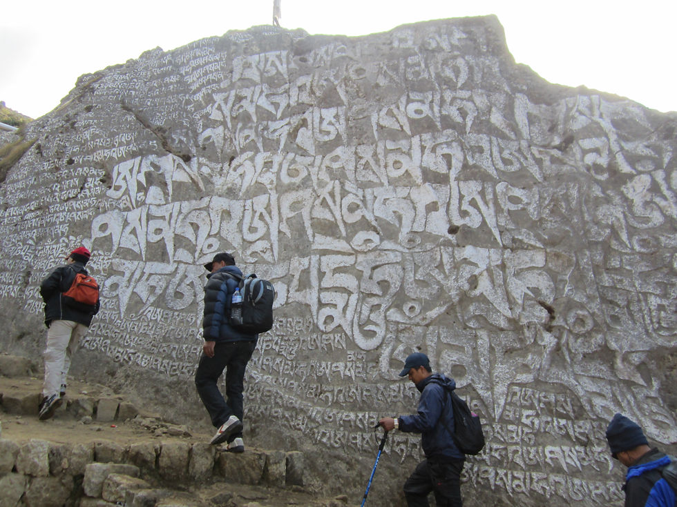 Four hikers ascend a slope in Nepal.