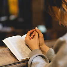 Christian woman reading bible in an ancient Catholic temple. Reading the Holy Bible in tem