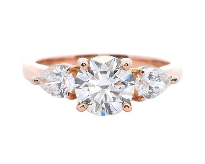 Trilogy engagement ring round brilliant with pear cuts rose gold.jpg