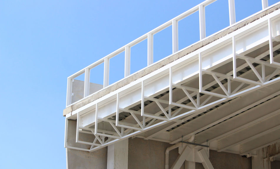 Estructura metálica blanca, vista de cerca con cielo azul, servicio herrería aluminio templados en México