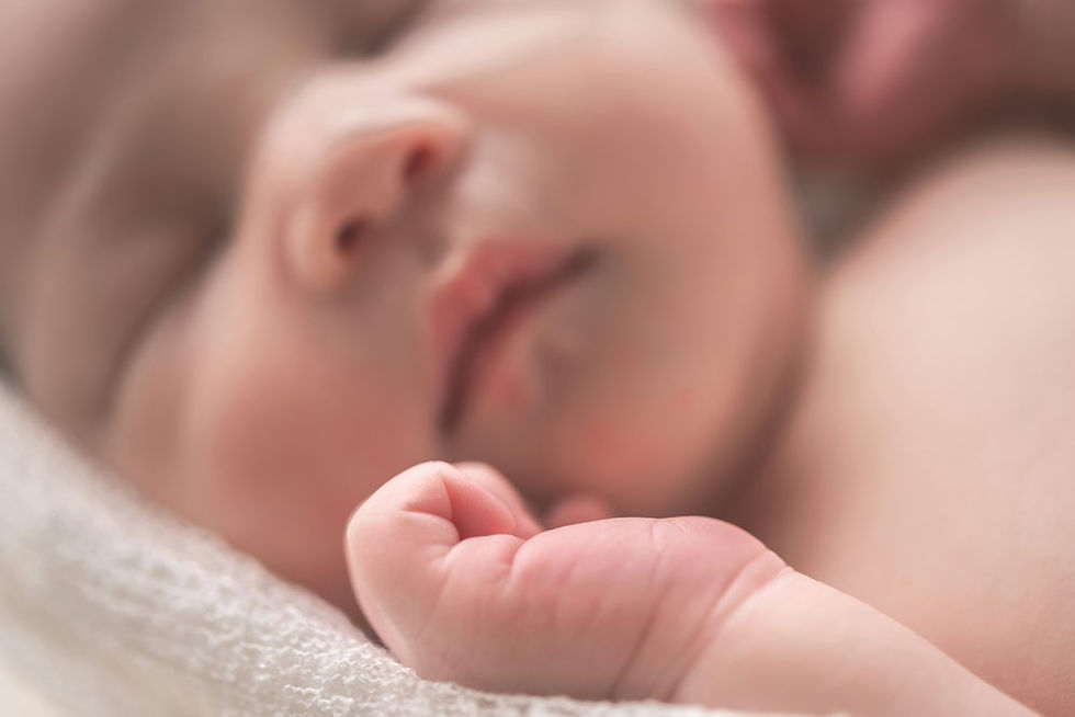 Close up of newborn baby with eyes closed