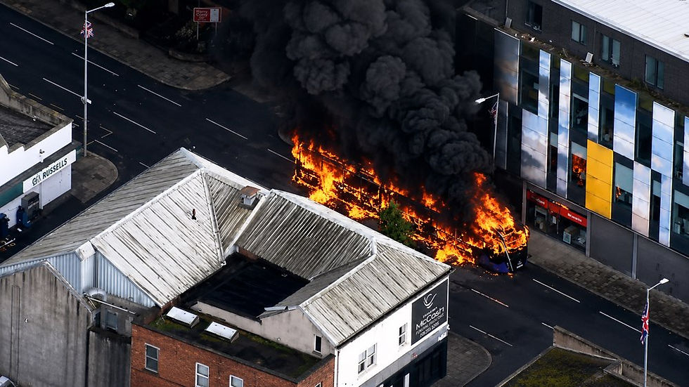 A glider bus set on fire earlier in June during street disorder In Belfast
