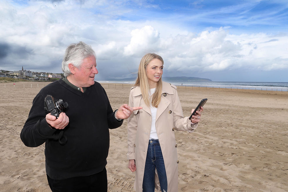Amy Donaghey, Causeway Coast and Glens Council’s Arts Marketing and Engagement Officer,getting some tips from photographer James Hughes at Castlerock Beach.
